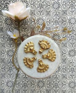 brass charms – Shop now: Close-up view of handcrafted brass charms with intricate boho detailing.
