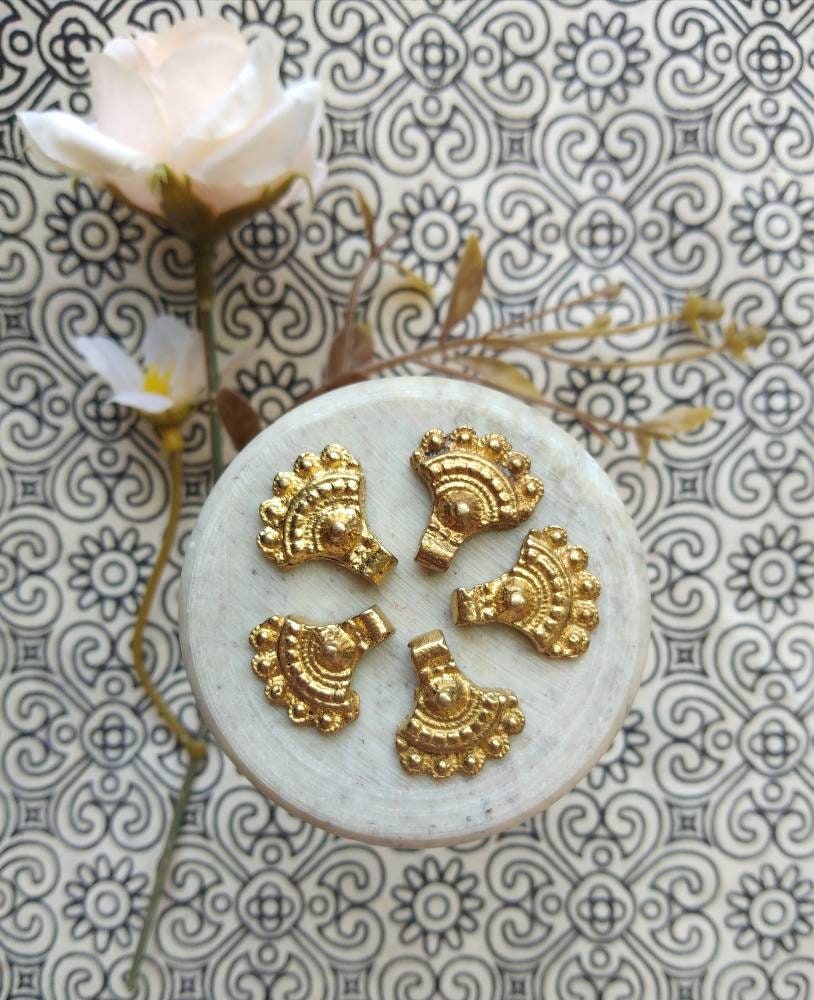 brass charms – Shop now: Close-up view of handcrafted brass charms with intricate boho detailing.