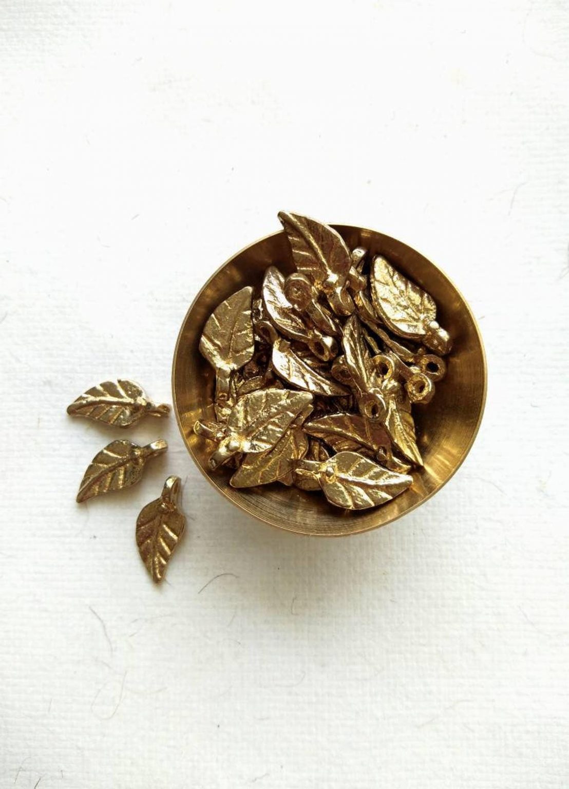 Leaves charms – Intricate leaf-shaped brass charms.