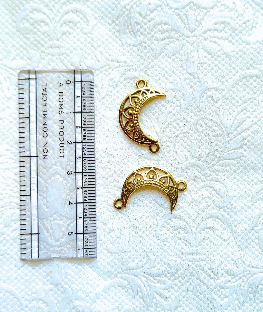 Filigree moon charm with loop in antique gold tone